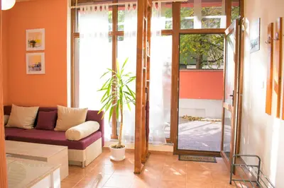 a living room with a couch and a sliding glass door at 4 Seasons apartments, A1 in Plovdiv