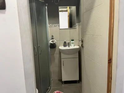 a small bathroom with a sink and a mirror at Vel House in Plovdiv