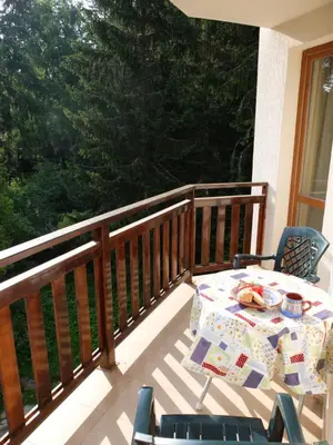 a table and chairs on a balcony with a table and chairs at Borovets Apartment, Villa Park in Borovets