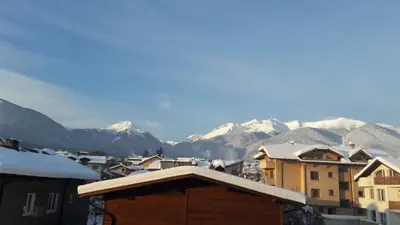 a view of a city with snow covered mountains at Bella Vista Guesthouse in Bansko