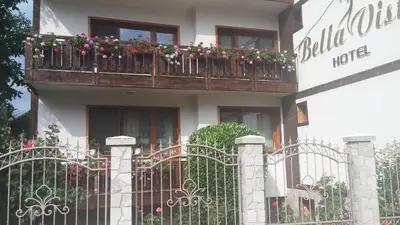 a building with a balcony with flowers on it at Bella Vista Guesthouse in Bansko