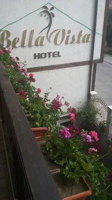 a sign for a hotel with flowers in front of it at Bella Vista Guesthouse in Bansko