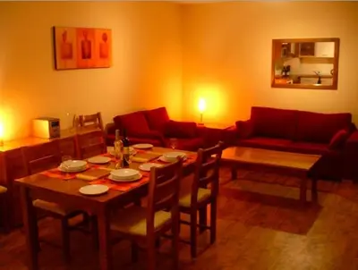 a living room with a table and a couch at MD Alexander Services Apartments in Bansko