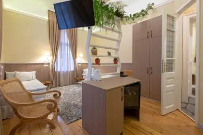 a living room with a desk and a chair at Temptation in Sofia - 24h Self Check-in in Sofia