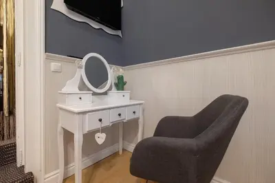 a dressing table with a mirror and a chair at Temptation in Sofia - 24h Self Check-in in Sofia
