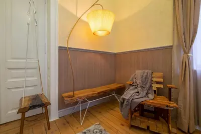 a room with a table and a bench and a lamp at Temptation in Sofia - 24h Self Check-in in Sofia