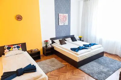 a bedroom with two beds with blue bows on them at Vitosha Blvd - Family and Friends Apart in Sofia