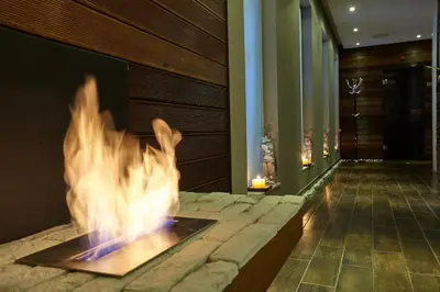 a fire pit in the lobby of a hotel at Belchin Garden SPA&Wellness in Belchin