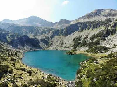a mountain lake in the middle of a valley at Great location near lift in Bansko