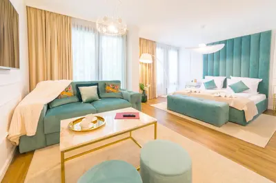 a living room with a couch and a bed at Boutique Apartments Blagoevgrad in Blagoevgrad