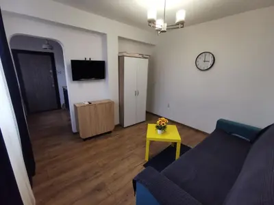 a living room with a couch and a table at Studio Oslo byPMM in Plovdiv