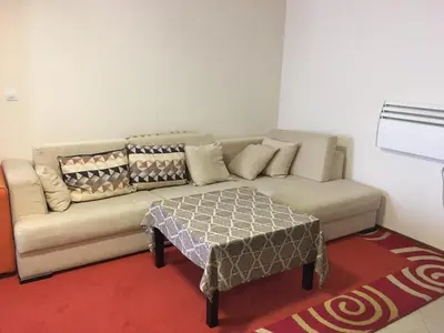 a living room with a couch and a table at Villa Bojinovi - Forest Nook 2 in Pamporovo