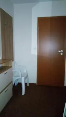 a room with a chair and a wooden door at Villa Bojinovi - Forest Nook 2 in Pamporovo