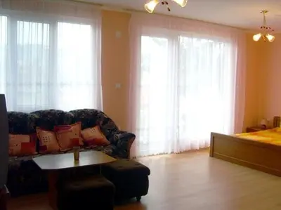 a living room with a couch and a table at Family Hotel Velevi in Velingrad
