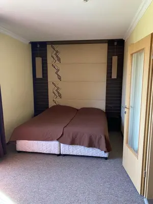 a bedroom with a large bed in a room at Iglika Bansko in Bansko