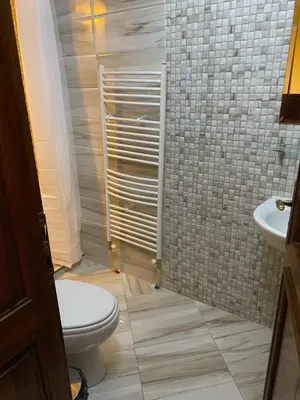 a bathroom with a toilet and a sink at Iglika Bansko in Bansko