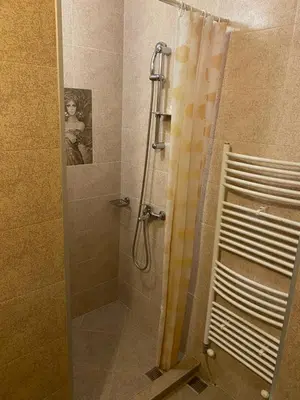 a shower with a shower curtain in a bathroom at Iglika Bansko in Bansko