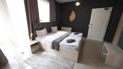 a bedroom with a large bed in a room at Mini Sofia in Sofia
