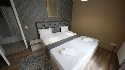 a bedroom with a bed with two towels on it at Mini Sofia in Sofia