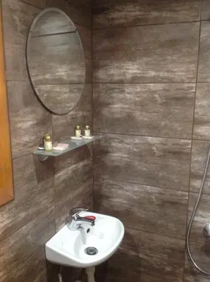 a bathroom with a sink and a mirror at Еднофамилна дървена къщичка in Beli Iskar