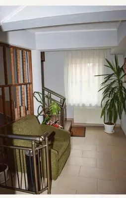 a living room with a couch and a window at Family Hotel Miglena in Govedartsi