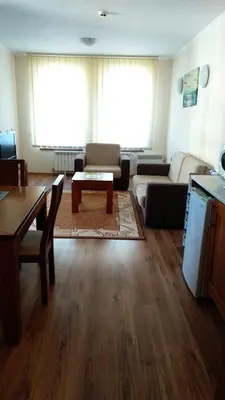a living room with a couch and a table at Ski Apartment D50 Cedar Lodge 4 in Bansko