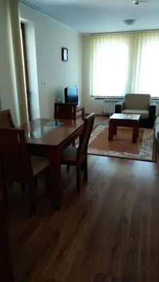 a living room with a wooden table and chairs at Ski Apartment D50 Cedar Lodge 4 in Bansko