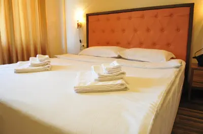 two towels are sitting on top of two beds at City Blagoevgrad Family Hotel in Blagoevgrad