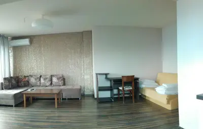 a living room with a couch and a table at City Blagoevgrad Family Hotel in Blagoevgrad