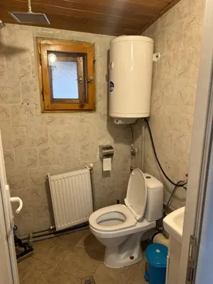 a bathroom with a toilet with a water tank at Borovets Gondola Apartment & Ski by Winter Bros in Borovets