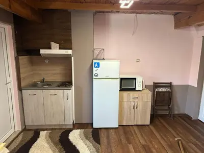 a kitchen with a refrigerator and a microwave at Borovets Gondola Apartment & Ski by Winter Bros in Borovets