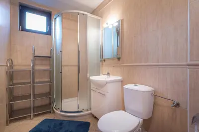a bathroom with a toilet and a shower at Mountain Escape Bansko 1BR apartment in Bansko