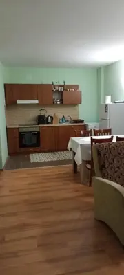 a kitchen with a table and a kitchen with a stove at Evrika Forest in Pamporovo