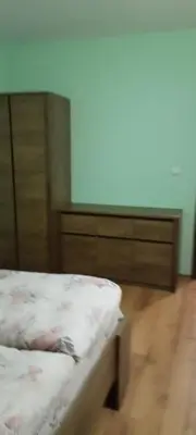 a bedroom with a bed and a wooden dresser at Evrika Forest in Pamporovo