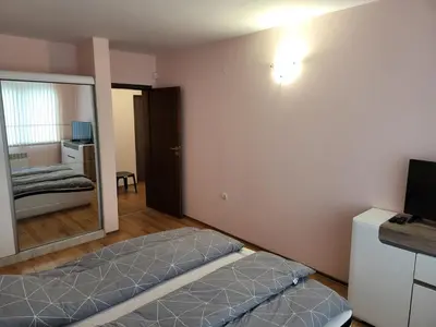 a bedroom with a bed and a television in it at Evrika Forest in Pamporovo
