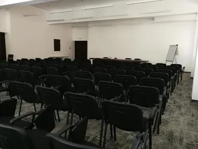 an empty room with chairs and a projection screen at Balkan Hotel in Chiflik