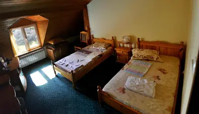 a bedroom with two beds and a window at Strandzhata's House in Pasarel