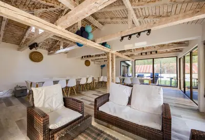 a dining room with wicker chairs and a table at Family Hotel Zornitsa in Ribarica