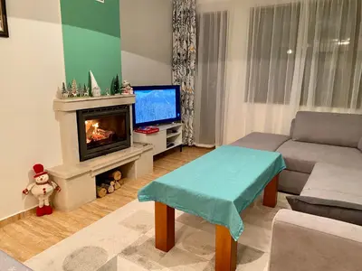 a living room with a couch and a fireplace at Aparthotel - Monastery 3, 1 Bedroom Apartment in Pamporovo