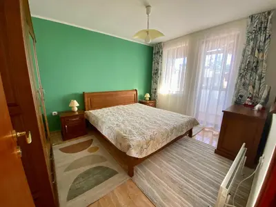 a bedroom with a bed and a green wall at Aparthotel - Monastery 3, 1 Bedroom Apartment in Pamporovo