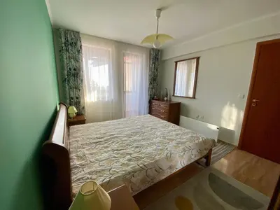 a bedroom with a bed in a green room at Aparthotel - Monastery 3, 1 Bedroom Apartment in Pamporovo