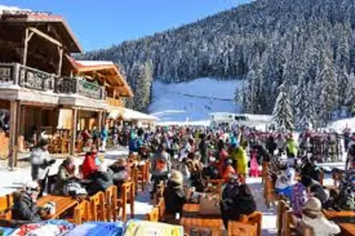 a crowd of people sitting outside of a ski lodge at F307 Studio Aspen Golf Resort Bansko in Bansko