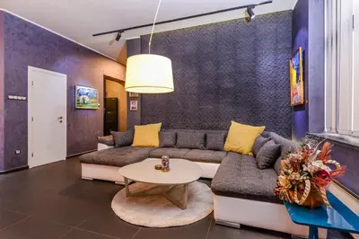 a living room with a couch and a table at Champs-Élysées Sofia 2-BDR, 2-BTHR Tsar Simeon Suite by Flat Mаnager in Sofia