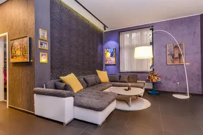 a living room with a couch and a table at Champs-Élysées Sofia 2-BDR, 2-BTHR Tsar Simeon Suite by Flat Mаnager in Sofia