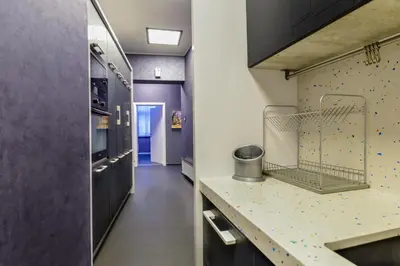 a kitchen with black cabinets and a counter top at Champs-Élysées Sofia 2-BDR, 2-BTHR Tsar Simeon Suite by Flat Mаnager in Sofia