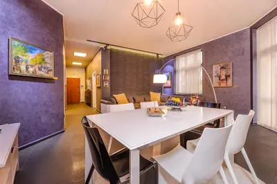 a kitchen and dining room with a white table and chairs at Champs-Élysées Sofia 2-BDR, 2-BTHR Tsar Simeon Suite by Flat Mаnager in Sofia