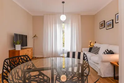 a living room with a glass table and a couch at cО́coEllie - Aesthetic 2BD Apt Near National Palace by Flat Mаnager in Sofia