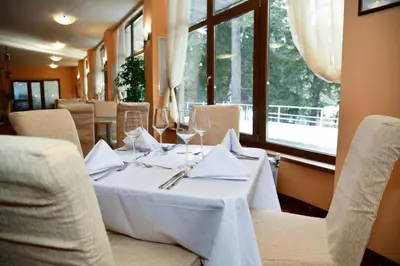 a dining room with a table with wine glasses at Hotel Borovets Edelweiss in Borovets