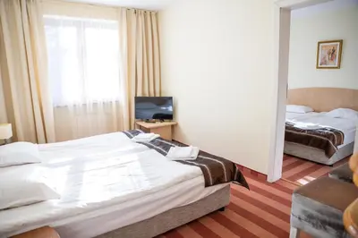 a hotel room with two beds and a television at Hotel Borovets Edelweiss in Borovets