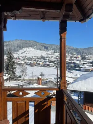 a view from the balcony of a house with snow at Guest House Roden Dom in Koprivshtitsa
